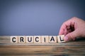 Crucial, wooden letters on the office desk