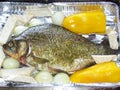 Crucian carp prepared for cooking on baking tray