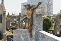 Crucified Jesus Christ on a cross on a grave in a cemetery Royalty Free Stock Photo