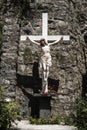 Crucifix against rock wall