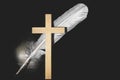 Crucifix against the background of a bird feather Royalty Free Stock Photo