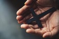 Crucifix cross in hand background Royalty Free Stock Photo