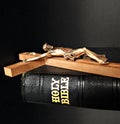 Wooden cross placed on top of Bible