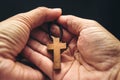 The crucifix is in the hands of a man who is praying for the blessing of his god with faith