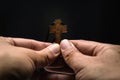 The crucifix is in the hands of a man who is praying for the blessing of his god with faith