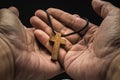 The crucifix is in the hands of a man who is praying for the blessing of his god with faith Royalty Free Stock Photo