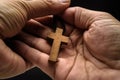 The crucifix is in the hands of a man who is praying for the blessing of his god with faith Royalty Free Stock Photo