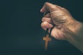 The crucifix is in the hands of a man who is praying for the blessing of his god with faith