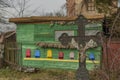 Crucifix near trees and bee house with bee on cross