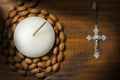 Crucifix with Rosary Bead and Votive Candle Royalty Free Stock Photo