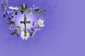 Crucifix and rosary with wild flower wreath on a purple background Royalty Free Stock Photo