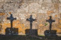 crucifix shadow on stone wall Royalty Free Stock Photo