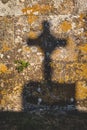 crucifix shadow on stone wall Royalty Free Stock Photo