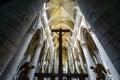 A crucifix is silhouetted in the medieval Notre Dame cathedral of Rouen, France