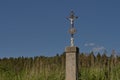 Crucifix standing by the wayside in the fields Royalty Free Stock Photo