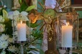 crucifixion of Christ and candles,a gilded cross in the church with the crucifixion of Jesus and two burning candles, Symbol of Royalty Free Stock Photo