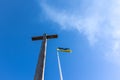 The crucifixion of Jesus Christ and the flag of Ukraine against the blue sky. Royalty Free Stock Photo