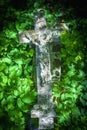 The crucifixion of Jesus Christ. Very old and ancient stone destroyed statue in the grass. Top view