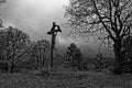 Crucifixion landmark in bleak landscape Good Friday scene, monochrome image