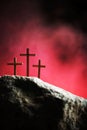 Crucifixion, resurrection of Jesus Christ. Three crosses against red sky on Calvary hill background. Christian Easter Royalty Free Stock Photo