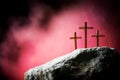 Crucifixion, resurrection of Jesus Christ. Three crosses against red sky on Calvary hill background. Christian Easter Royalty Free Stock Photo