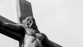 A monochrome photo of crucifixion sculpture against sky background Royalty Free Stock Photo