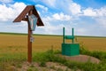 Crucifixion and water well Royalty Free Stock Photo