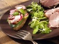 Crude, dried gammon ham with sandwich, salad on plate Royalty Free Stock Photo