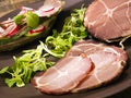 Crude, dried gammon ham with sandwich, salad on plate Royalty Free Stock Photo