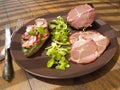 Crude, dried gammon ham with sandwich, salad on plate Royalty Free Stock Photo