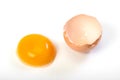 Crude egg yolk and shell on a white background. Close up. Top view Royalty Free Stock Photo