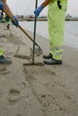 Crude oil spill in Gibraltar and the Andalusian coast. Unrecognizable workers cleaning the sand