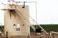 Crude oil tank on farmland Royalty Free Stock Photo