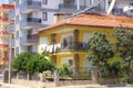 A crude onestory house against the backdrop of modern residential buildings, Alanya, Turkey, April 2021 Royalty Free Stock Photo