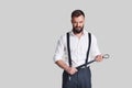 So cruel! Angry young man in formalwear carrying a belt and look Royalty Free Stock Photo