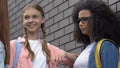 Cruel teenagers bullying, pushing biracial girl to wall, intimidation in school
