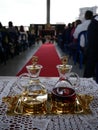 Cruets with water and wine ready for catholic mass with red carpet and people in the background Royalty Free Stock Photo