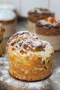 Cruffin as Easter cake decorated with raisins, dried apricots and sugar powder on kitchen table Royalty Free Stock Photo