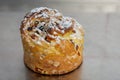 Cruffin as Easter cake decorated with raisins, dried apricots and sugar powder on kitchen table