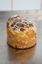 Cruffin as Easter cake decorated with raisins, dried apricots and sugar powder on kitchen table Royalty Free Stock Photo