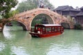 Cruise boat and picturesque bridge in the ancient water town Wuzhen (Unesco), China Royalty Free Stock Photo