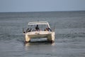 Cruise boat with blue fish net lay  a beach side Royalty Free Stock Photo