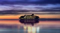cruise  ship  in port at night cloudy dramatic sunset orange and lilac  sky water reflection blue sea   color In harbor Tallinn E Royalty Free Stock Photo