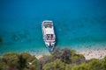 Cruise boat seen from above on clear blue water