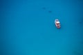 Cruise boat seen from above on clear blue water
