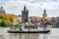 Cruise boat on Vltava river and Old Town Bridge Tower and Charles bridge, Prague, Czech Republic Royalty Free Stock Photo