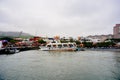 Cruise ferry boat and port on Clean Tamsui river in a raining day in winter