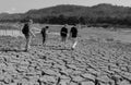 Cruise guests are walking over dry earth at the Mekong River near Luang Brabang Royalty Free Stock Photo