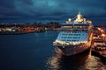 Cruise liner docked at city waterfront at night