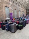 Cruise passengers luggage at a collection point in a cruise terminal.